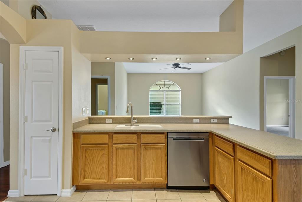 3715 Mulberry Grove Loop Leesburg, FL 34748 - Photo 9 of 48 a kitchen with a sink and a refrigerator