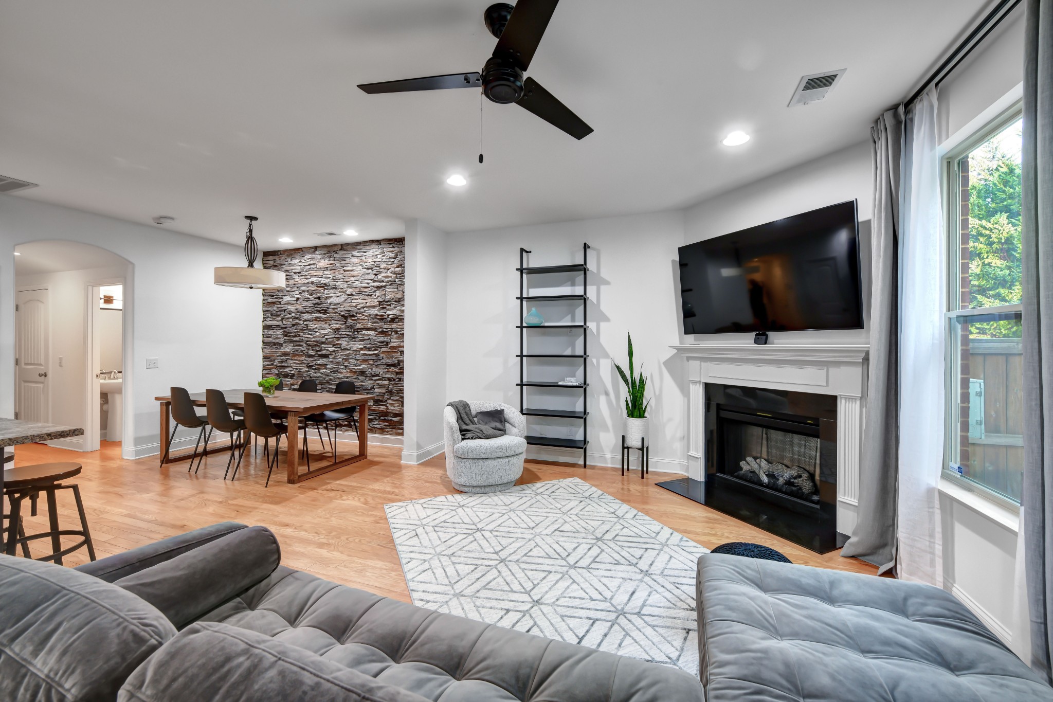 305 Windgrove Terrace Mount Juliet, TN 37122 - Photo 5 of 20 a living room with furniture a fireplace and a flat screen tv