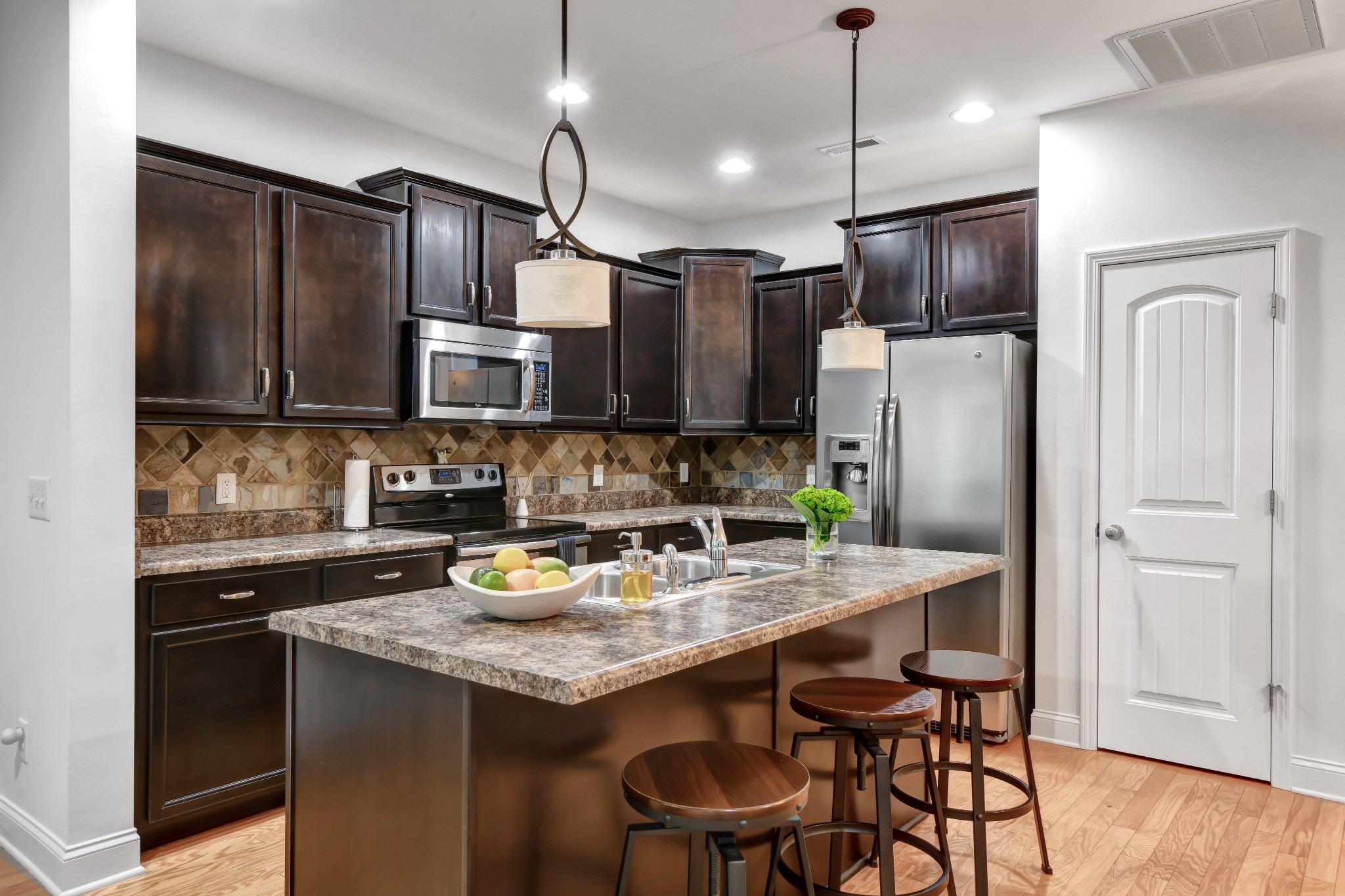 305 Windgrove Terrace Mount Juliet, TN 37122 - Photo 7 of 20 a kitchen with stainless steel appliances granite countertop a refrigerator a sink dishwasher a stove and a refrigerator with wooden floor