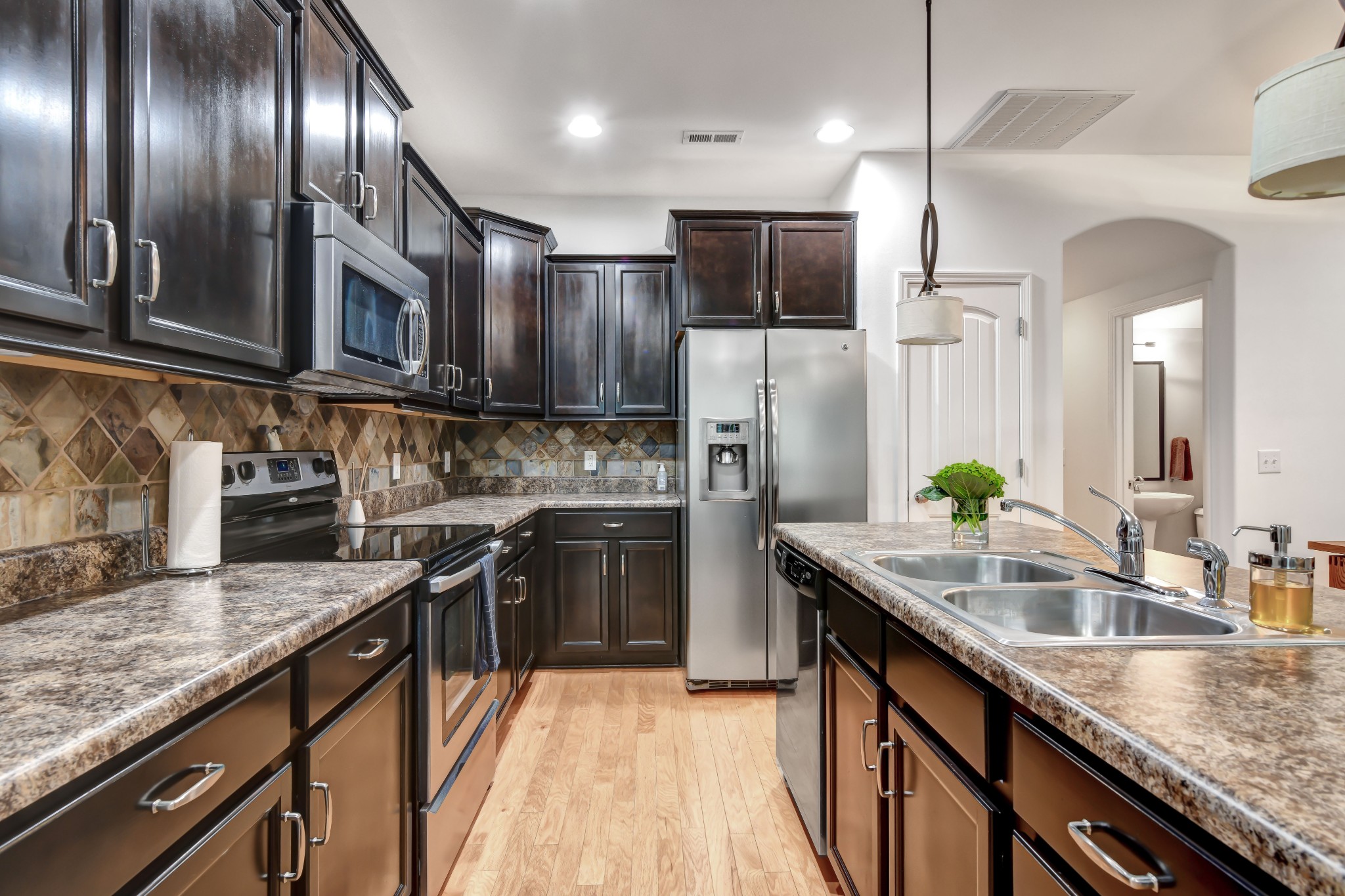 305 Windgrove Terrace Mount Juliet, TN 37122 - Photo 8 of 20 a kitchen with stainless steel appliances granite countertop a sink a stove and a refrigerator