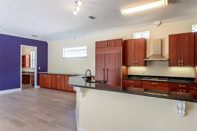 a bedroom with a large bed and a chandelier