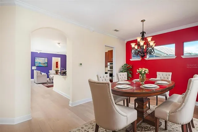 a living room with furniture and a view of kitchen