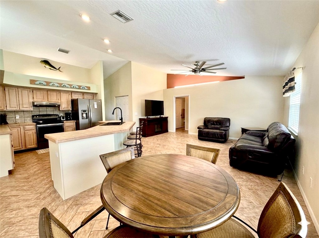 686 Caravan Terrace Sebastian, FL 32958 - Photo 12 of 24 a living room with furniture and a flat screen tv