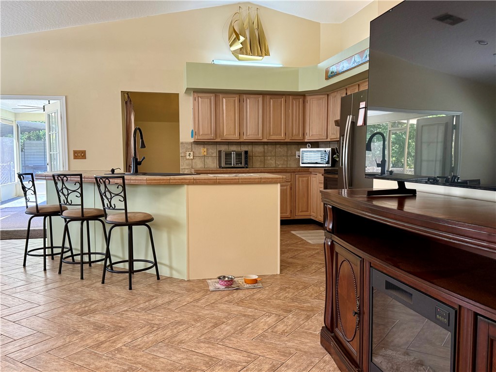 686 Caravan Terrace Sebastian, FL 32958 - Photo 13 of 24 a kitchen with a table chairs sink and cabinets