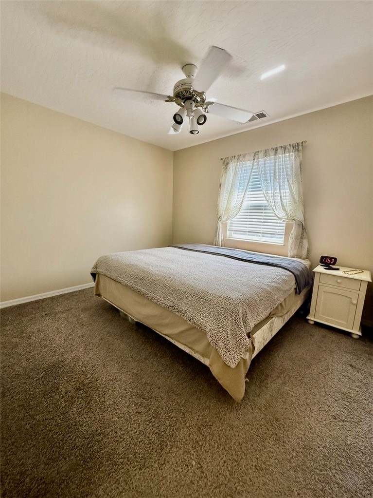 686 Caravan Terrace Sebastian, FL 32958 - Photo 15 of 24 a bedroom with a bed and a chandelier
