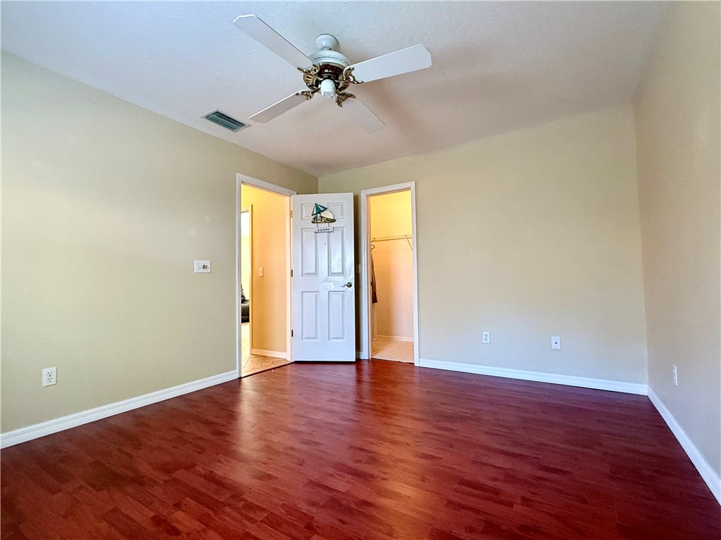 686 Caravan Terrace Sebastian, FL 32958 - Photo 17 of 24 a view of an empty room with a window and wooden floor