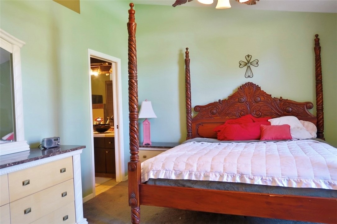 686 Caravan Terrace Sebastian, FL 32958 - Photo 18 of 24 a bedroom with a bed and a dresser