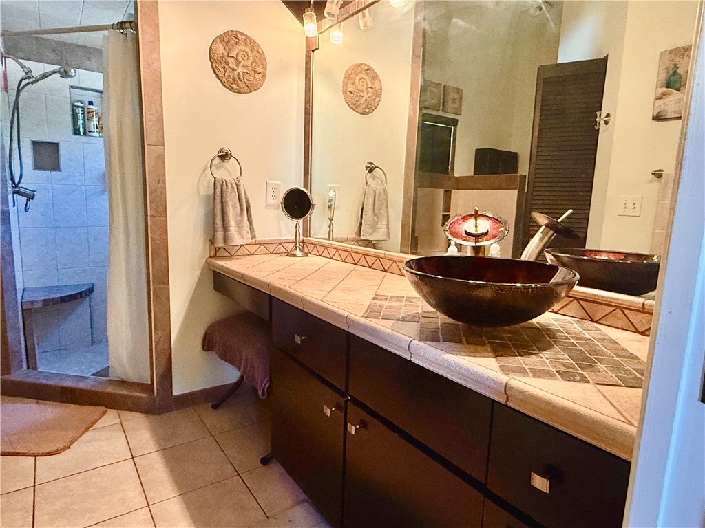 686 Caravan Terrace Sebastian, FL 32958 - Photo 20 of 24 a bathroom with a granite countertop sink and a mirror