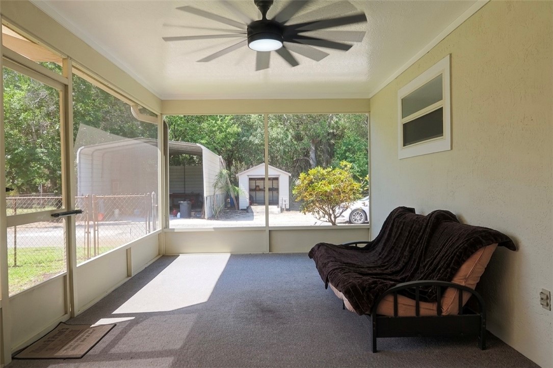 686 Caravan Terrace Sebastian, FL 32958 - Photo 22 of 24 a living room with furniture and a large window