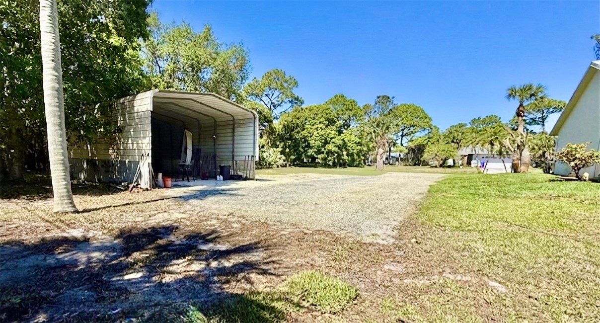 686 Caravan Terrace Sebastian, FL 32958 - Photo 24 of 24 a view of a house with a yard and potted plants