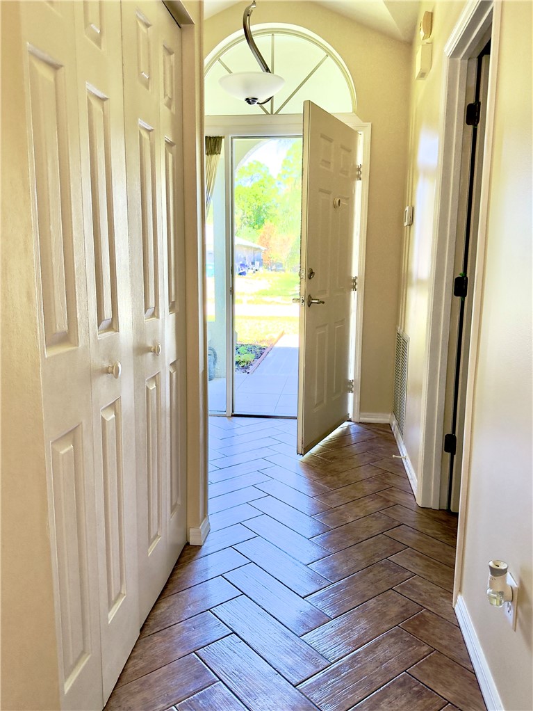 686 Caravan Terrace Sebastian, FL 32958 - Photo 8 of 24 a view of a hallway with wooden floor and staircase