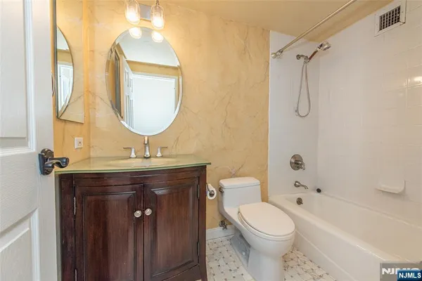 a bathroom with a toilet a sink and a mirror