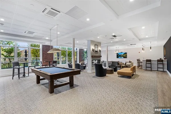 a room with lots of furniture and a potted plant