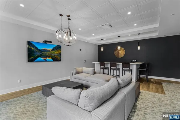 a living room with furniture and a chandelier