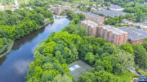 an aerial view of residential house with outdoor space and trees all around