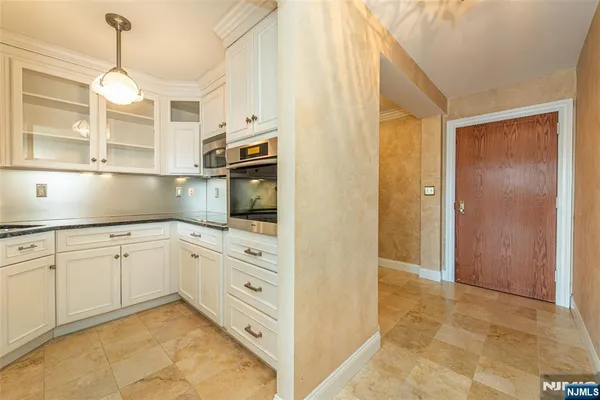 a kitchen with granite countertop cabinets and window