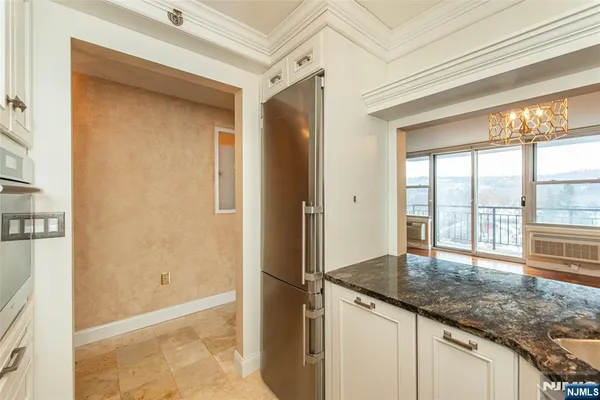 a hallway with sliding door and front door