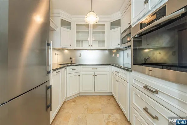 a kitchen with cabinets and a stove