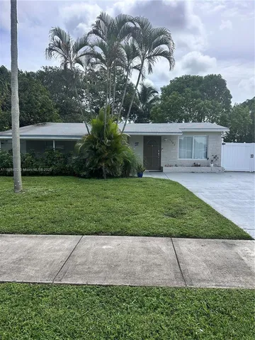 a view of a house with a yard and plants
