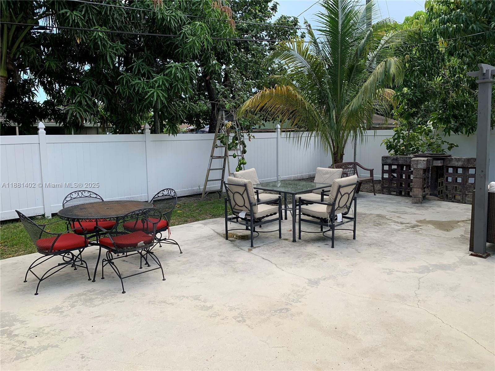 6180 Southwest 42nd Court Davie, FL 33314 - Photo 12 of 25 a backyard of a house with table and chairs