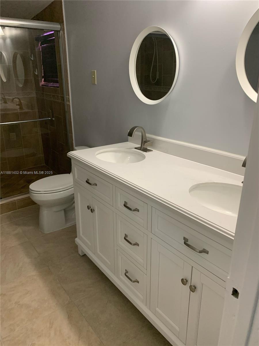 6180 Southwest 42nd Court Davie, FL 33314 - Photo 14 of 25 a bathroom with a toilet sink and mirror