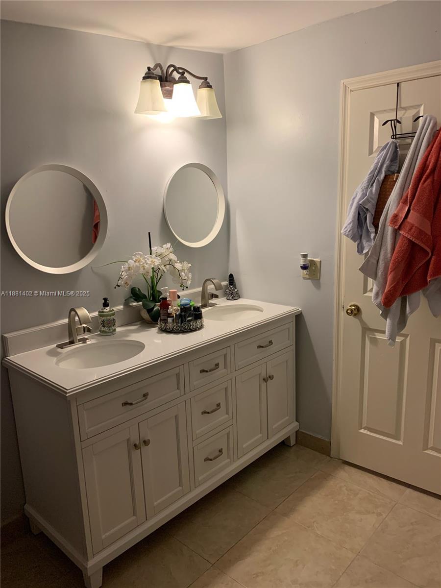 6180 Southwest 42nd Court Davie, FL 33314 - Photo 15 of 25 a bathroom with a double vanity sink and a mirror