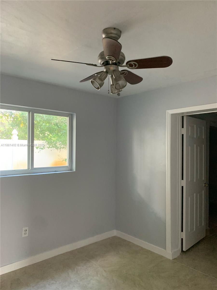 6180 Southwest 42nd Court Davie, FL 33314 - Photo 20 of 25 an empty room with a window and a fan