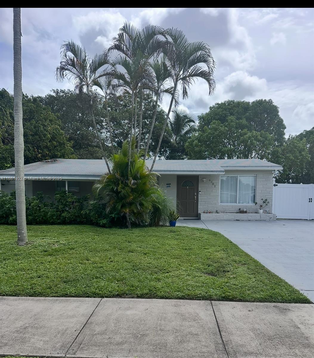 6180 Southwest 42nd Court Davie, FL 33314 - Photo 2 of 25 a front view of a house with garden