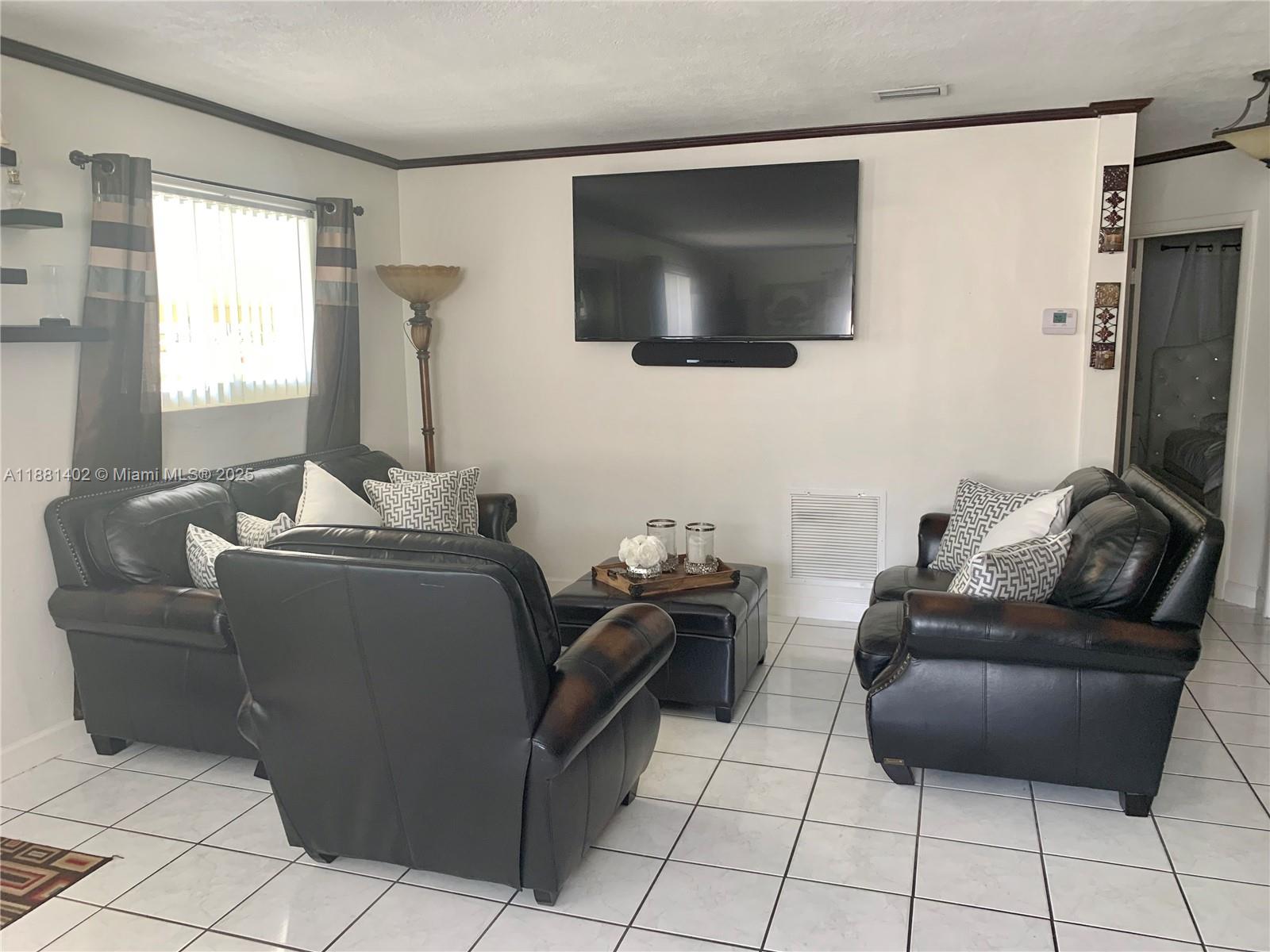 6180 Southwest 42nd Court Davie, FL 33314 - Photo 5 of 25 a living room with furniture and a flat screen tv