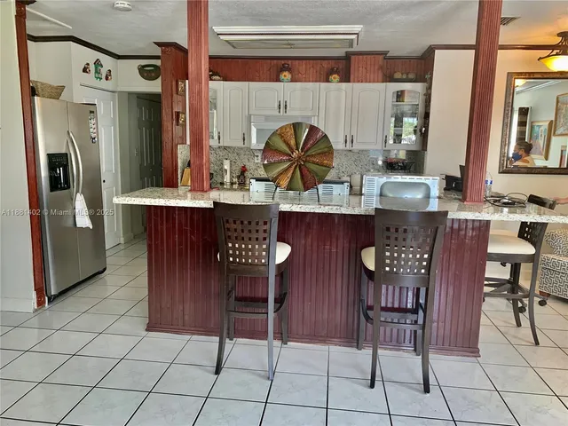 a kitchen with a sink a table and chairs