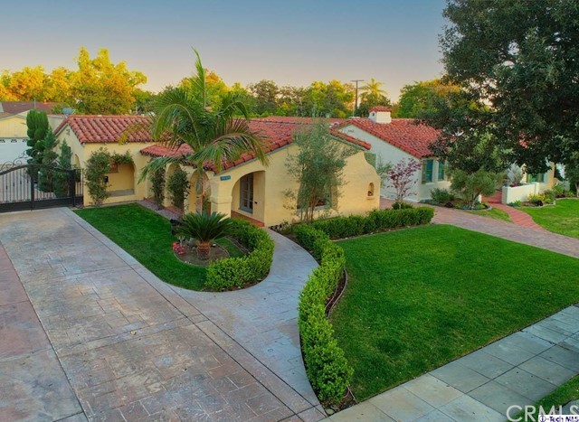 1408 Cleveland Road Glendale, CA 91202 - Photo 1 of 1 a view of a big house with a big yard and potted plants