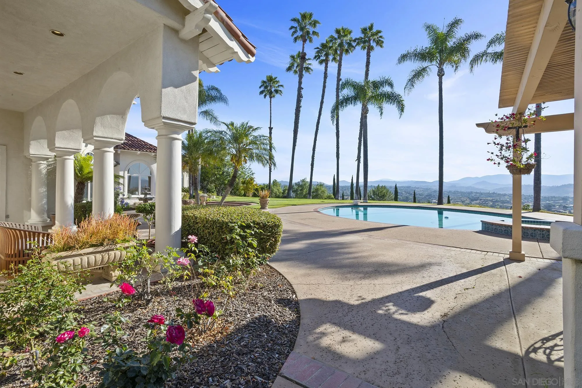 4 Rollingview Lane Fallbrook, CA 92028 - Photo 26 of 32 a view of a white house with a yard and potted plants