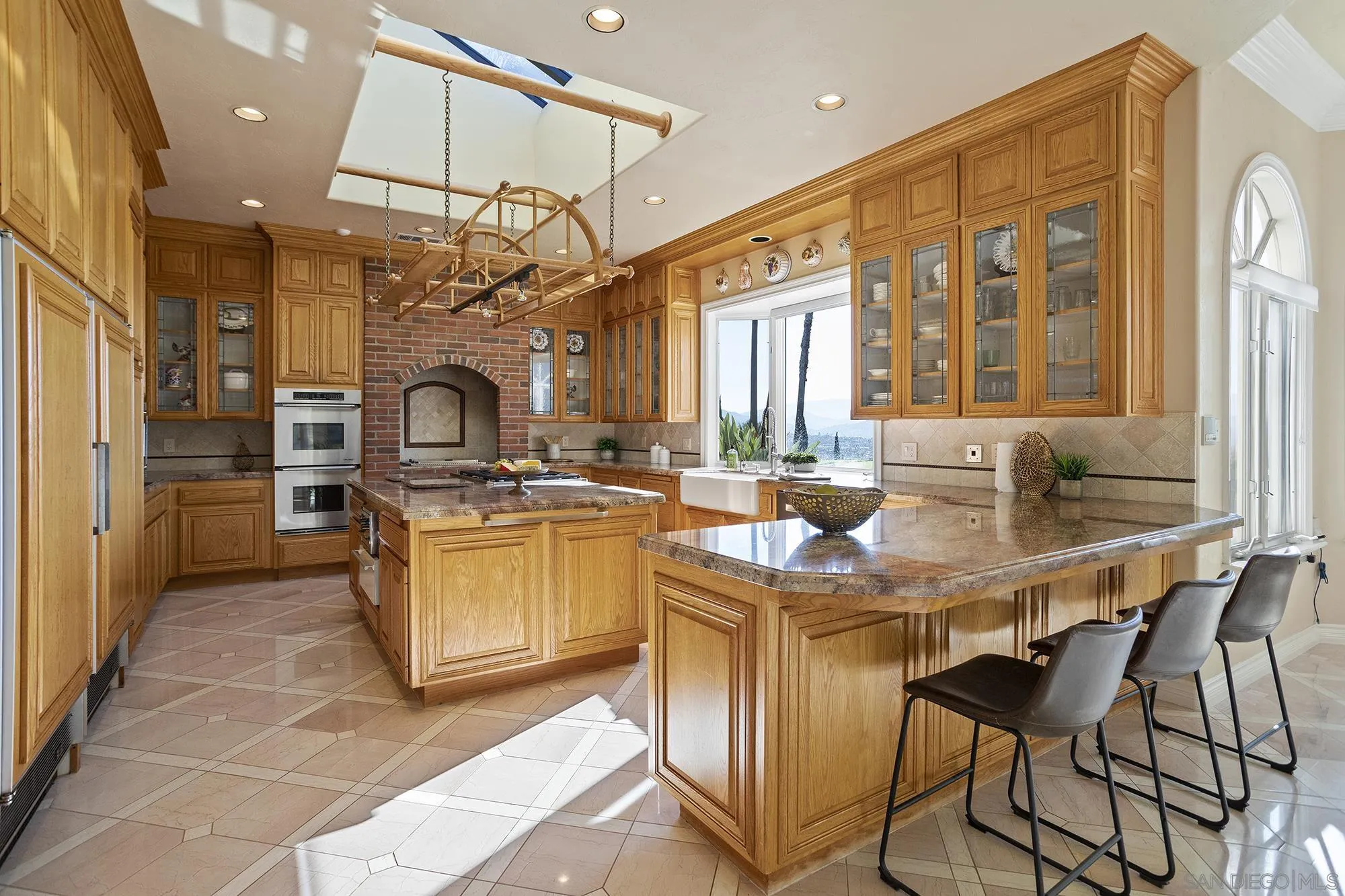 4 Rollingview Lane Fallbrook, CA 92028 - Photo 9 of 32 a kitchen with stainless steel appliances granite countertop a sink and a refrigerator