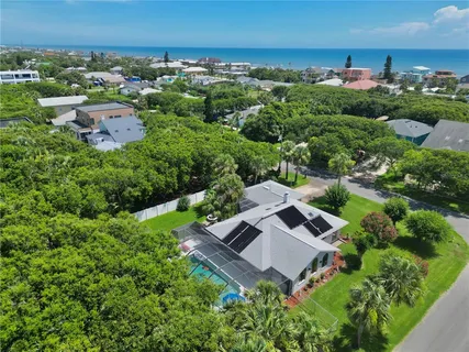 an aerial view of a house with a yard