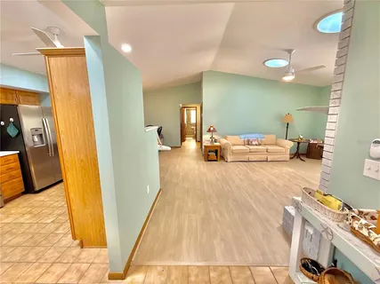 a view of a living room kitchen with furniture and a wooden floor