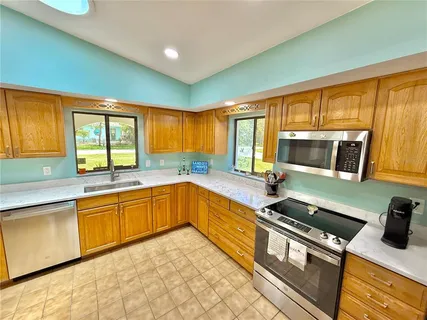 a view of a patio with a table and chairs under an umbrella