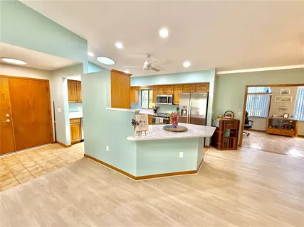 a view of a house with backyard sitting area and swimming pool