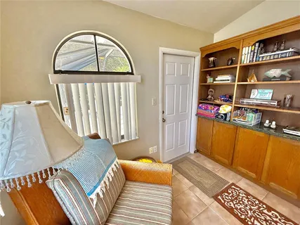 a view of a patio with a table and chairs under an umbrella