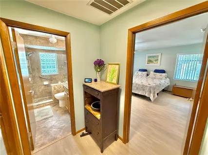 an aerial view of residential house with outdoor space and trees all around