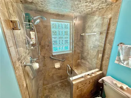 an aerial view of residential house with outdoor space and trees all around