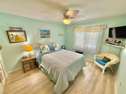 an aerial view of residential houses with outdoor space and trees