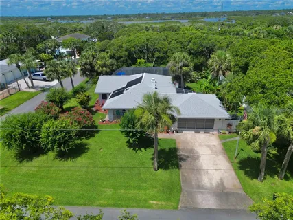 a kitchen with stainless steel appliances granite countertop a refrigerator a sink and a stove