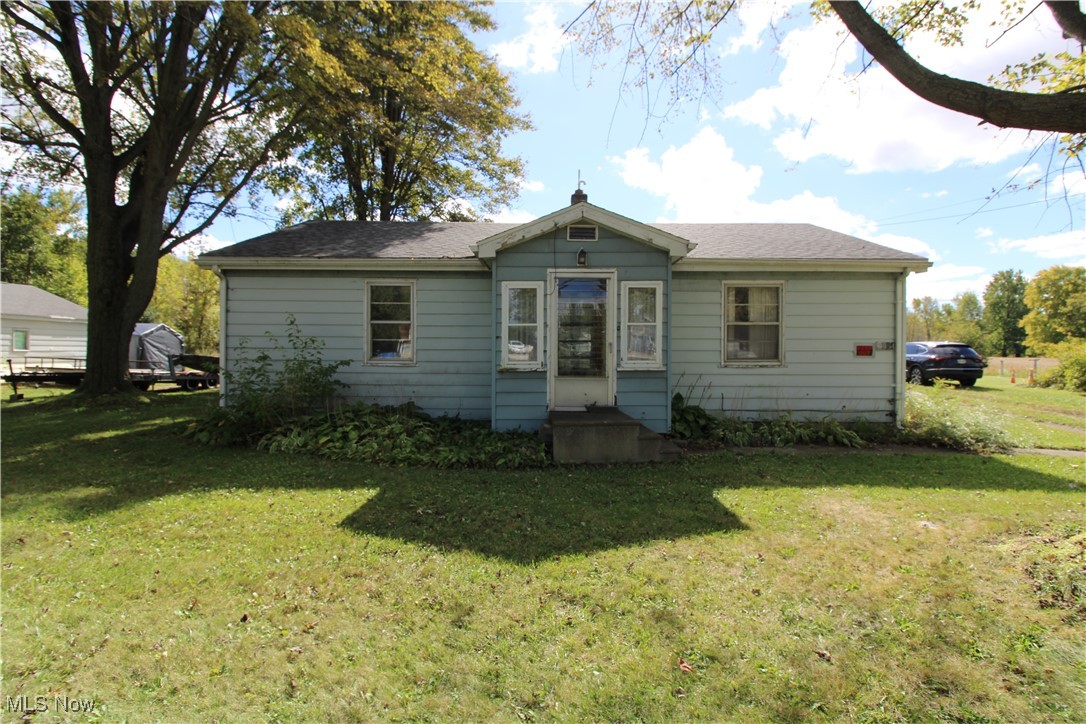 5084 West Fremont Road Port Clinton, OH 43452 - Photo 6 of 19 Rear view of property featuring a lawn