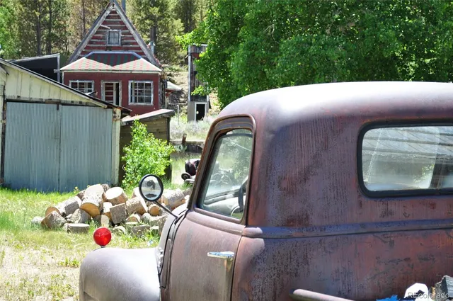 a view of a porch with furniture and a yard