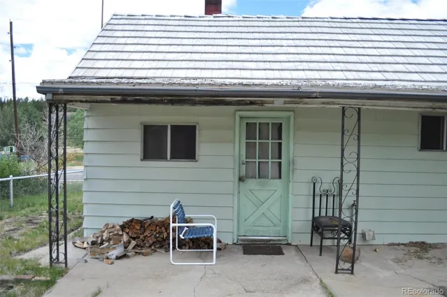 a view of backyard with chairs and a potted plant
