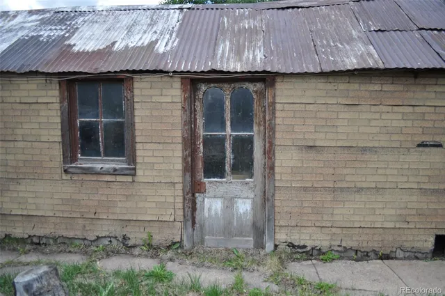 a view of a house with a yard next to a lake