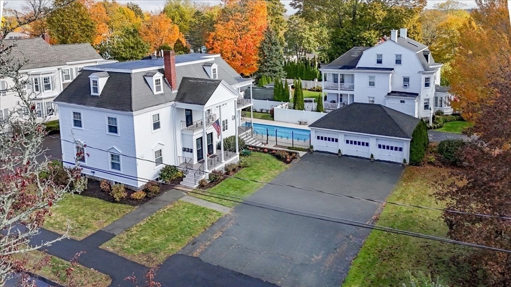 an aerial view of a house with a yard