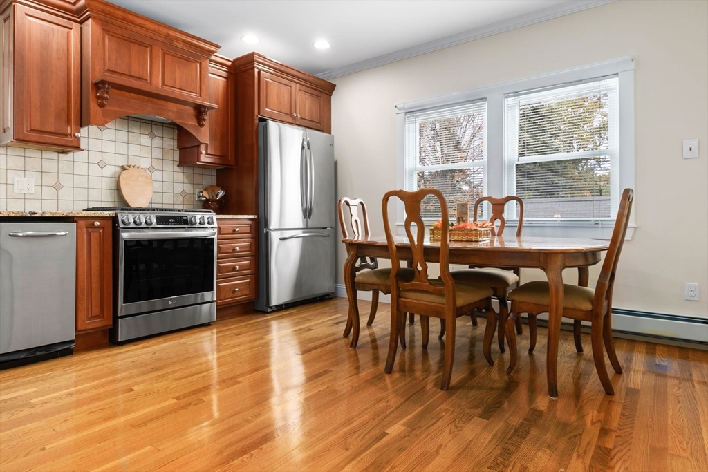 20 Ash Street, Unit 1 Danvers, MA 01923 - Photo 18 of 42 a view of a dining room with furniture window and wooden floor