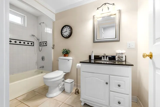 a bathroom with a bathtub shower and a sink