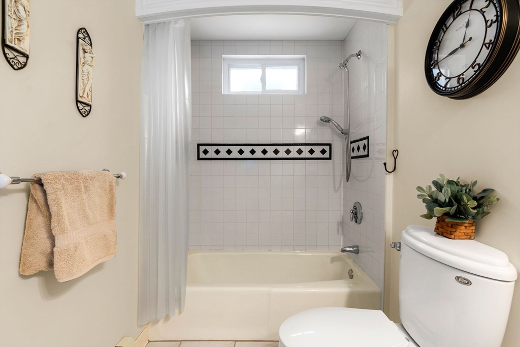 20 Ash Street, Unit 1 Danvers, MA 01923 - Photo 21 of 42 a bathroom with a bathtub shower and a sink